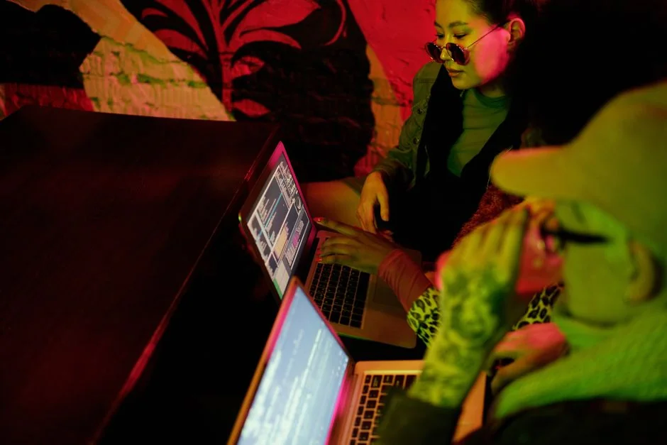 Close-up of an open laptop on a table displaying a website outdoors.